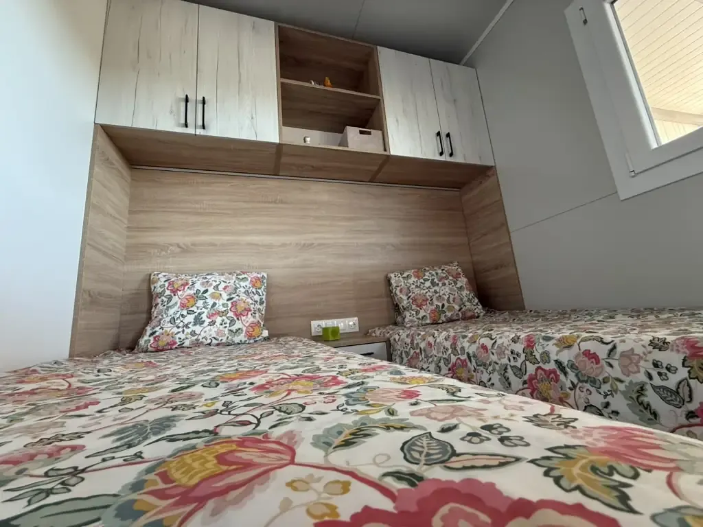 Twin bedroom detail with storage above the beds