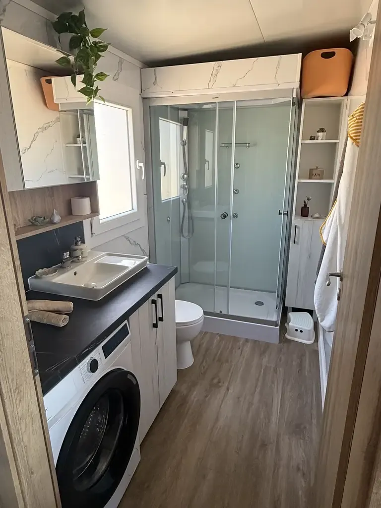 Bathroom with shower and washing machine