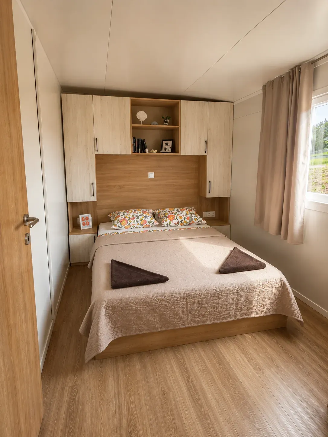 Double bedroom with overhead storage and window